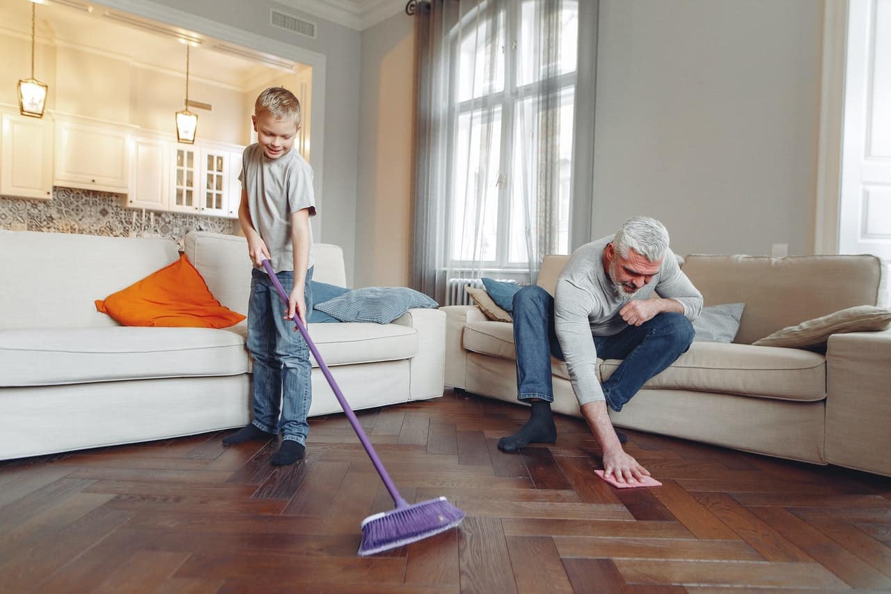 A father and his son cleaning the floor.
