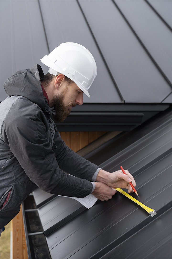 Worker on a roof during warm-weather exterior construction