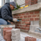 Masonry repair work on brick and concrete steps for Queens property maintenance