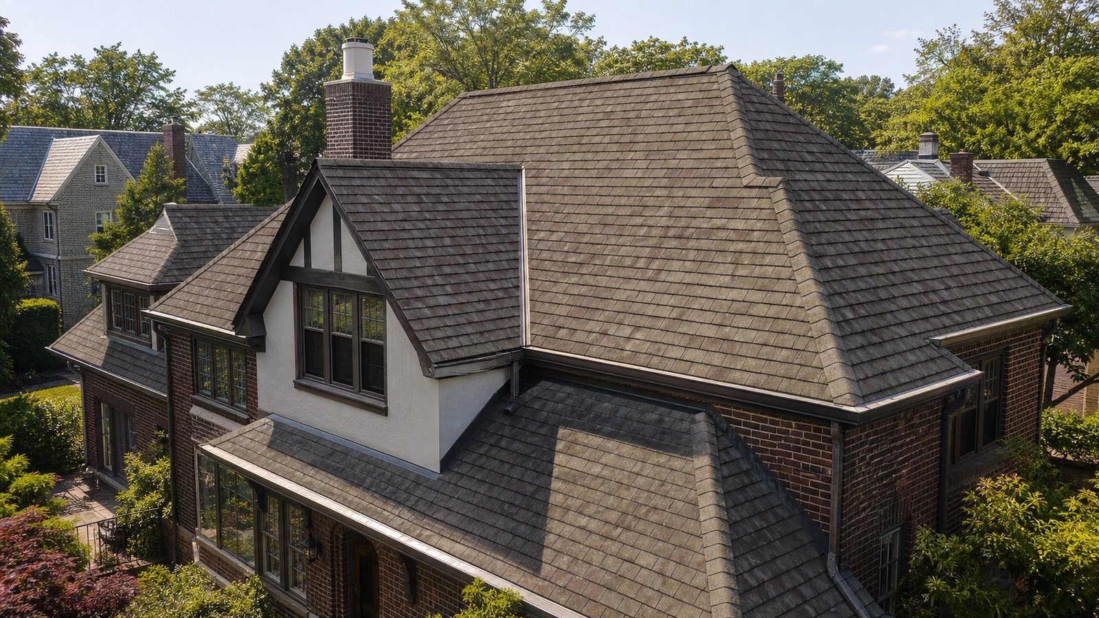 Warm cedar-shake-look asphalt shingle roof on a traditional Queens home