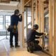Contractors coordinating framing and building systems during a Queens home addition